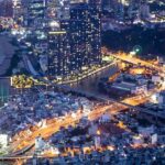 A breathtaking view of Saigon skyline from above under different lights during the night.