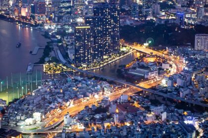 A breathtaking view of Saigon skyline from above under different lights during the night.