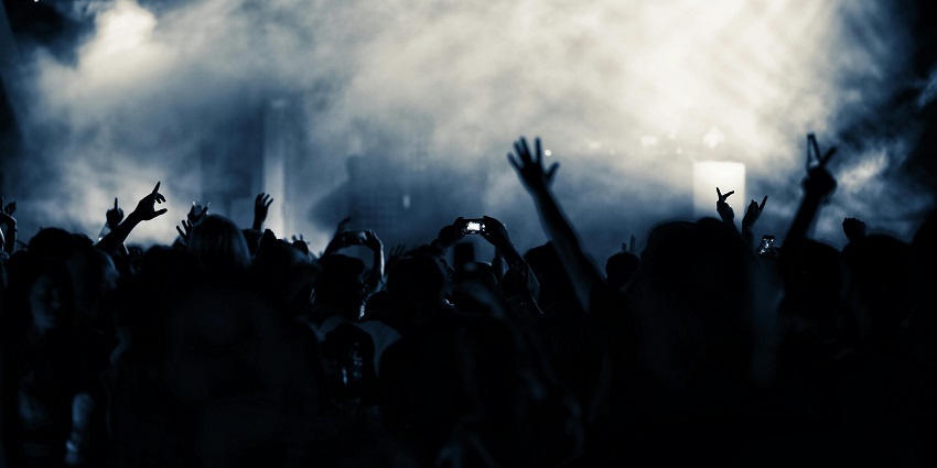 People raising their hands and enjoying a lively event at vietnam nightlife.
