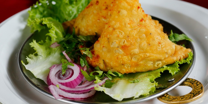Close-up of crispy fried food arranged on a saucer, showcasing its golden-brown texture.