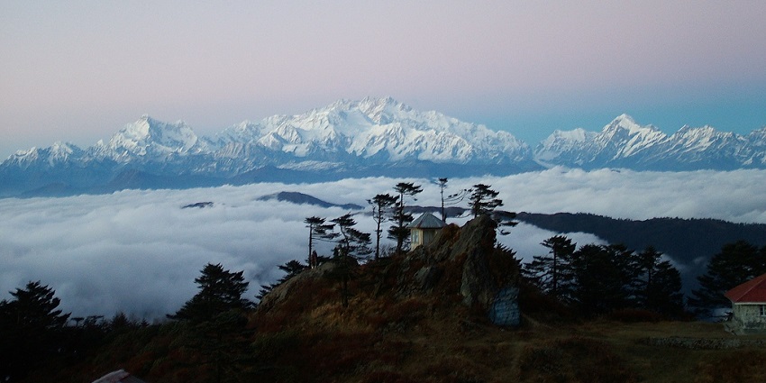 A breathtaking view of snow-capped mountains and blanket of misty air in Sandakphu.