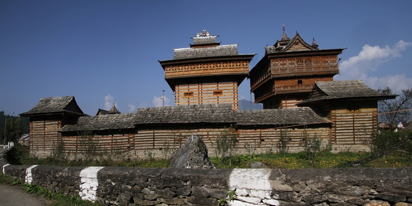 Featuring traditional Himachali architecture with intricate woodwork and scenic mountain views.