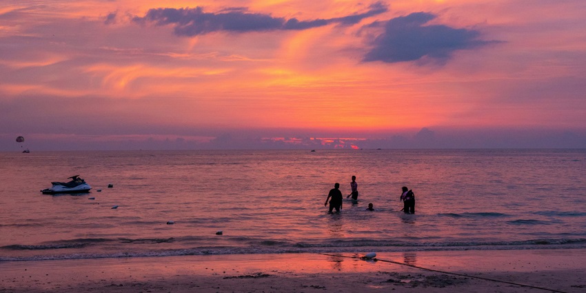 A breathtaking view of Pantai Cenang at sunset turning the sky in shades of pink.