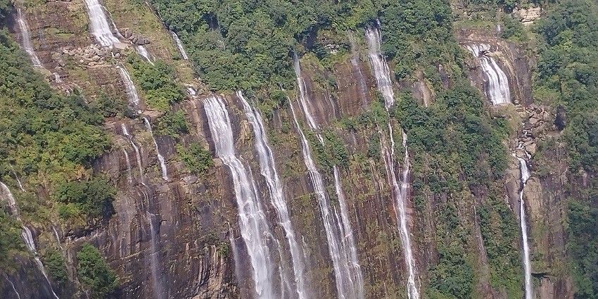 A picture of a beautiful waterfall located near the popular Mawsmai Caves