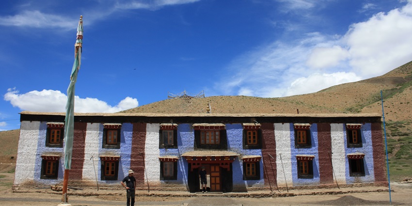 A picture of a historical monastery in Himachal Pradesh with a barren hill in background