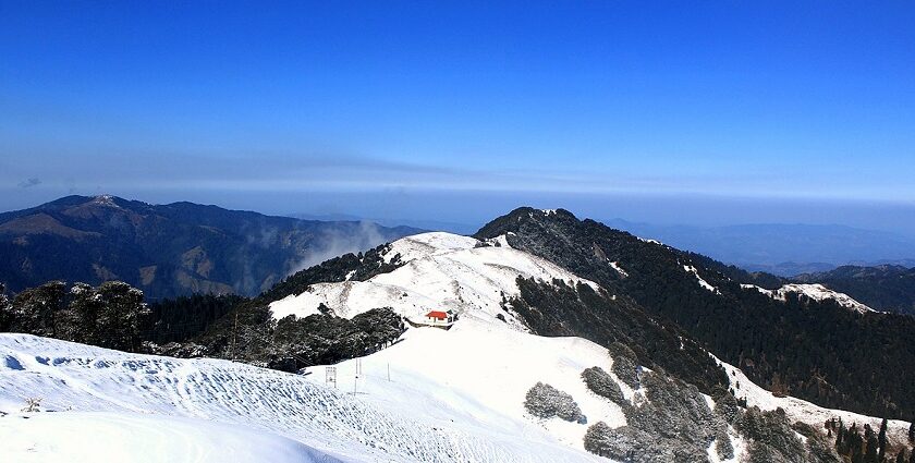 panoramic image of the beautiful Shikari Devi Wildlife Sanctuary covered in snow