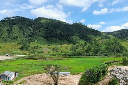 A stunning view of a valley in Shillong surrounded by lush greenery and mountains.