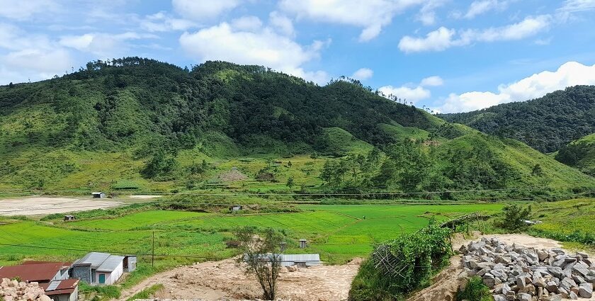 A stunning view of a valley in Shillong surrounded by lush greenery and mountains.