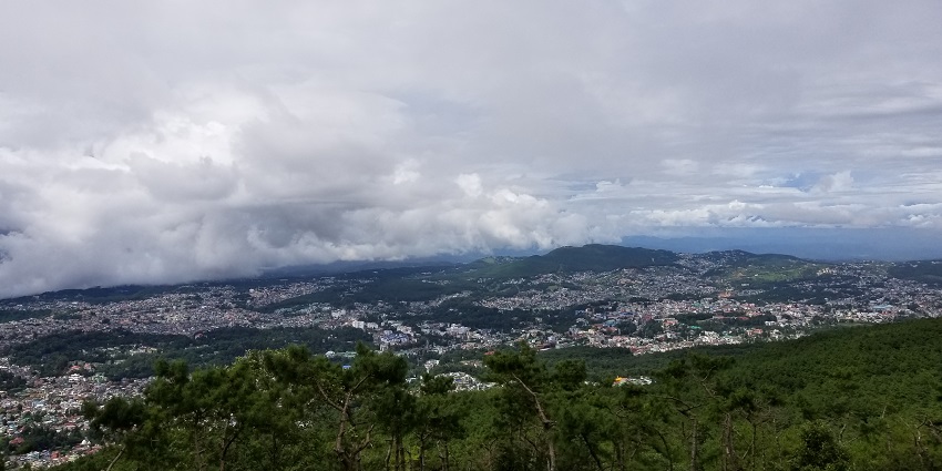 An aerial view of a famous hill station in Meghalaya near the Mawjymbuin Caves with views of mountains and cityscape