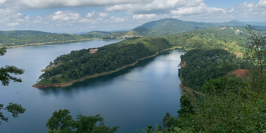 Aerial view of Shillong Umiam lake surrounded by lush green rolling hills