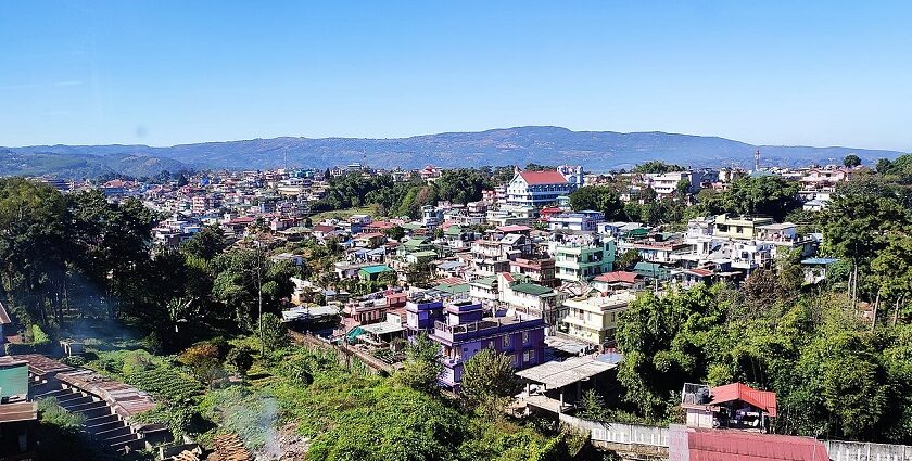 A picture taken from a hill showing the lower city of Shillong during day time