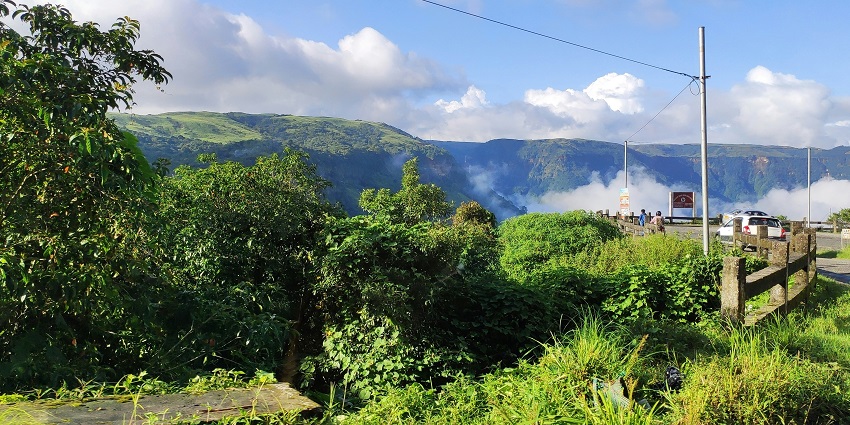 Stunning view from the Shillong Peak with lush green trees and mountains in the backdrop.