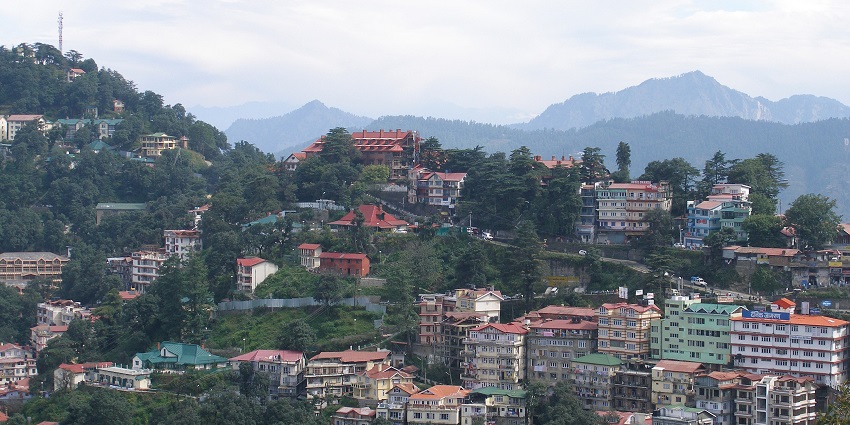 A panoramic view of Shimla city with numerous establishments amidst lush greenery
