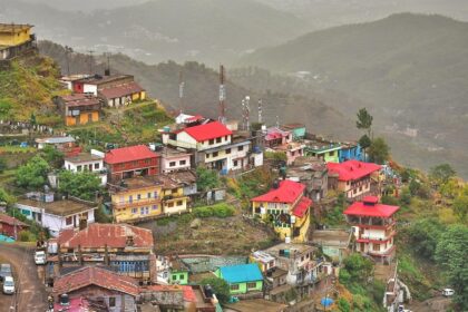 A breathtaking aerial view of a lot of houses on top of a mountain range during the day.