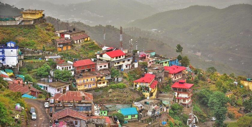 A breathtaking aerial view of a lot of houses on top of a mountain range during the day.