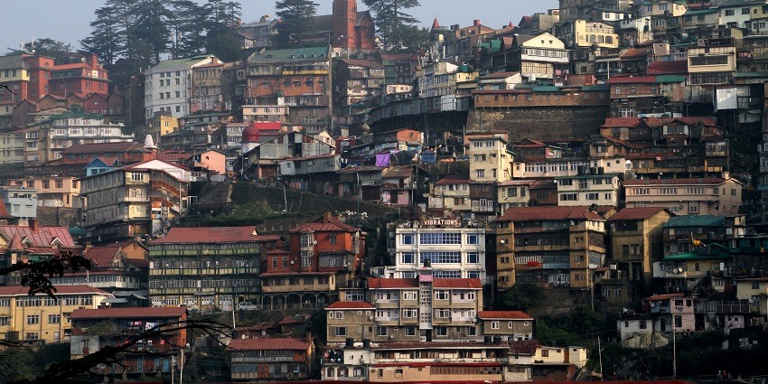 Scenic view of Shimla's cityscape with lush hills and charming architecture.