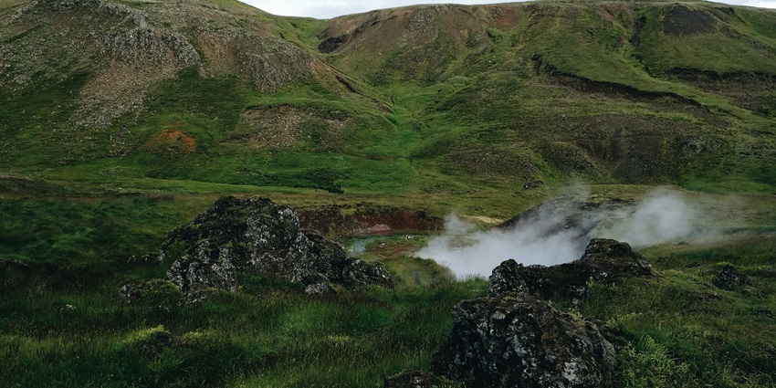 An idyllic snap of the blue hot water spring following down the stream in rocks