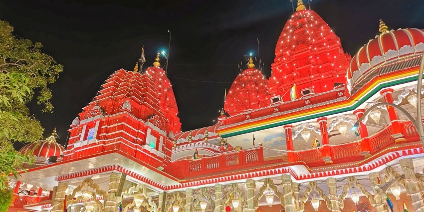 A red sandstone Jain temple with golden idols and a bird hospital and an alluring architecture.
