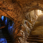 A picture of a cave system with 2 entrances and a big interior, clicked from the inside of the cave