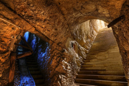 A picture of a cave system with 2 entrances and a big interior, clicked from the inside of the cave