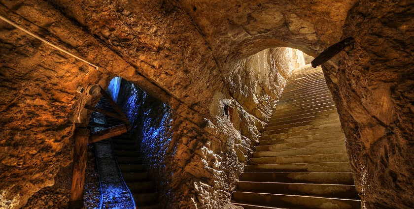 A picture of a cave system with 2 entrances and a big interior, clicked from the inside of the cave