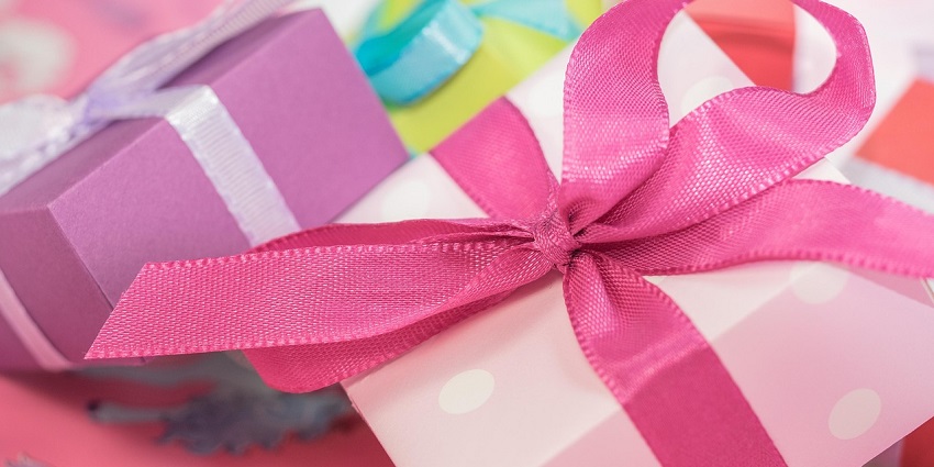 Image of small gift boxes in colourful wrappers wrapped with cute dotted print and small bows
