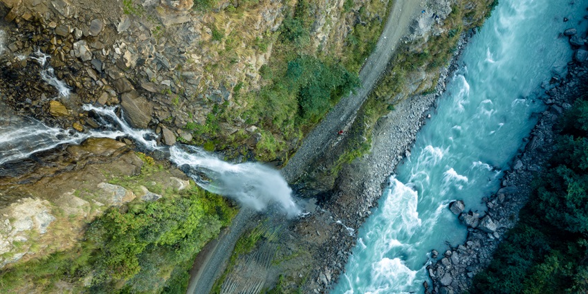 Scenic snapshot of the beautiful waterfall along with the alluring river following next to it