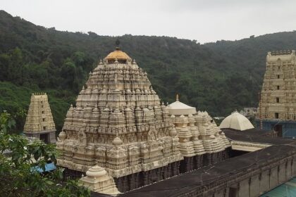 A breathtaking view of a temple in Andhra Pradesh under dense clouds during the daytime.