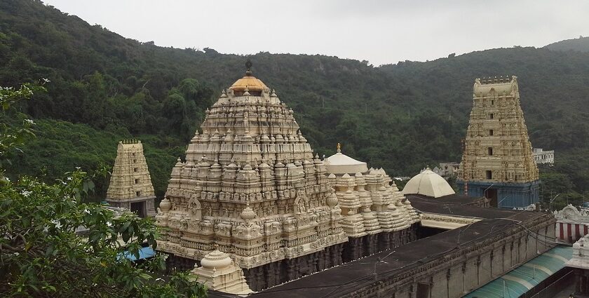 A breathtaking view of a temple in Andhra Pradesh under dense clouds during the daytime.