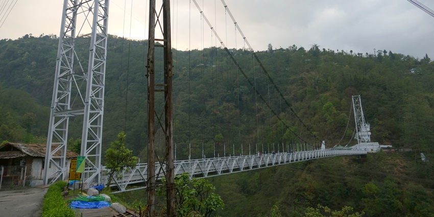 A picture of a massive suspension bridge in Sikkim with a mountain in the background