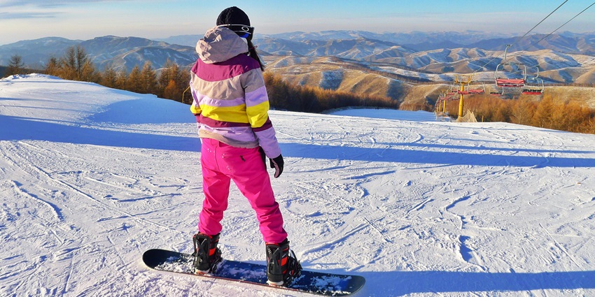 Enjoy skiing while gliding down snow-covered slopes surrounded by majestic mountains