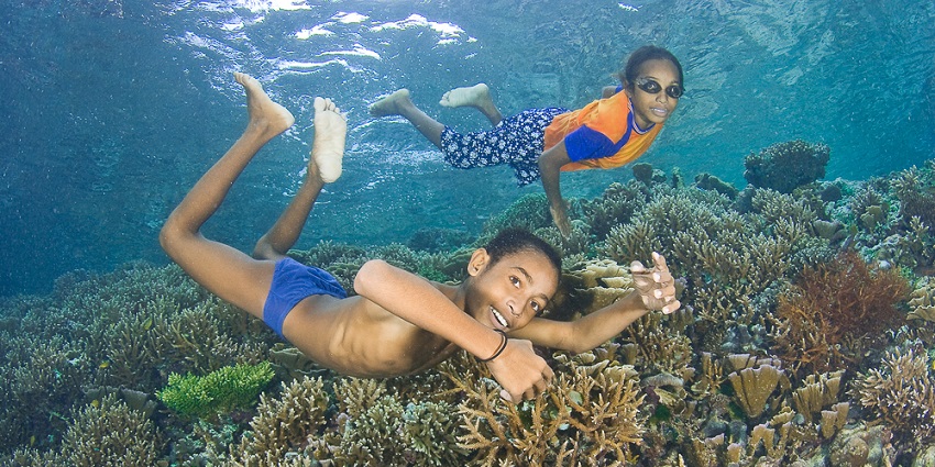 A picture of trained children enjoying water sports in Bali by snorkelling
