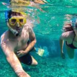 A picture of 2 people enjoying snorkelling in Thailand under the clear blue waters