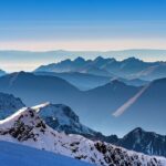 A breathtaking landscape of snow-covered mountains during the daytime in Switzerland.