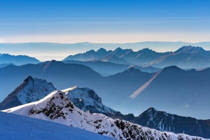 A breathtaking landscape of snow-covered mountains during the daytime in Switzerland.