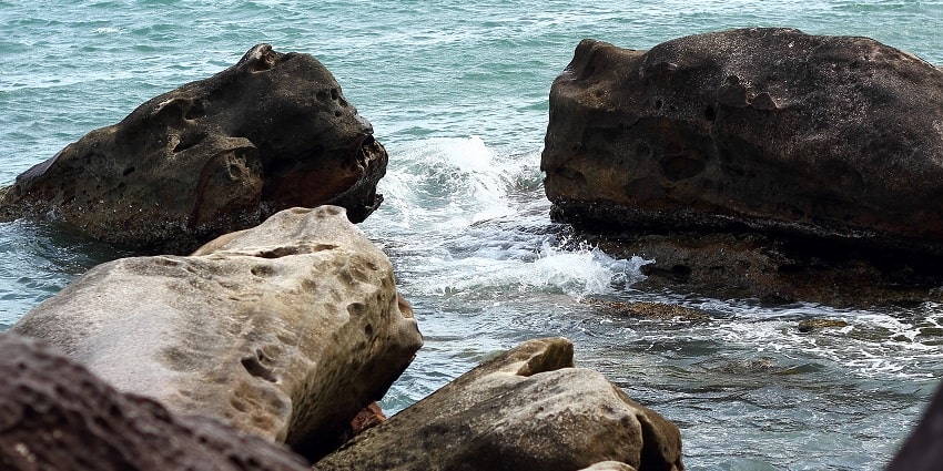 Frothy waves hitting the rocks at Sokha Beach, one of the top beaches near Phnom Penh.