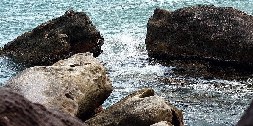 A view of waves hitting the giant rocks at Sokha Beach, one of the best Cambodia beaches.