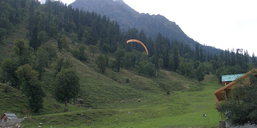 A picture of tourists enjoying paragliding at the Solang Valley near the Tibetan Monastery Manali