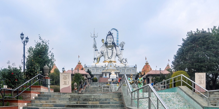 A picture of a temple in Namchi with a tall statue of lord Shiva in sitting position