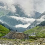 Camping in Sonmarg covered in green meadows and snow-capped mountains in the background