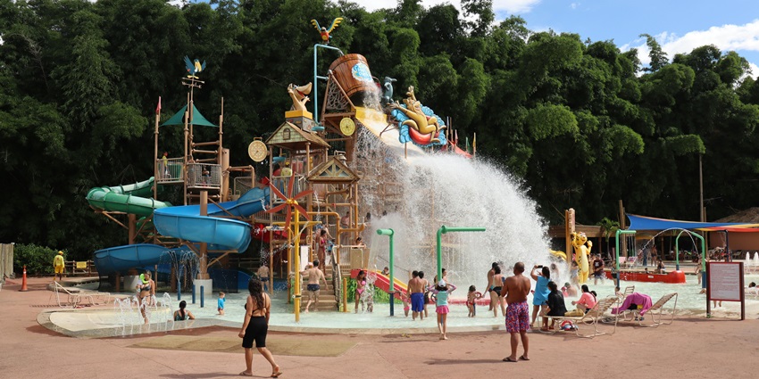 Water ride featuring twists, turns, and splash landings amidst a tropical jungle theme.