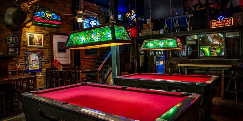 Pool tables in a sports bar for people to have fun