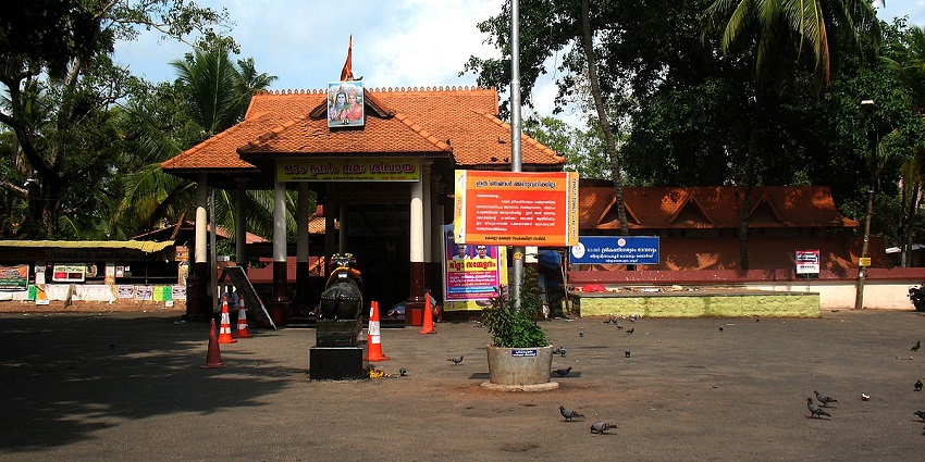 A small and old Shiva Temple with trees behind
