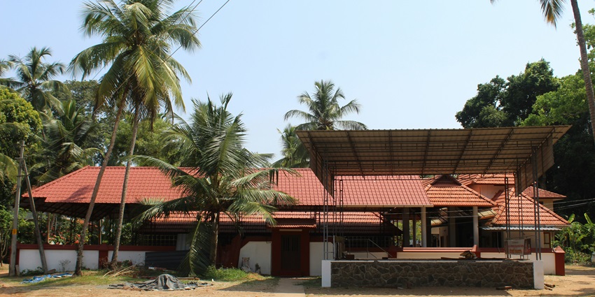 Sri Ayyappan Kavu Temple with stunning architecture and red roofs near palm trees.