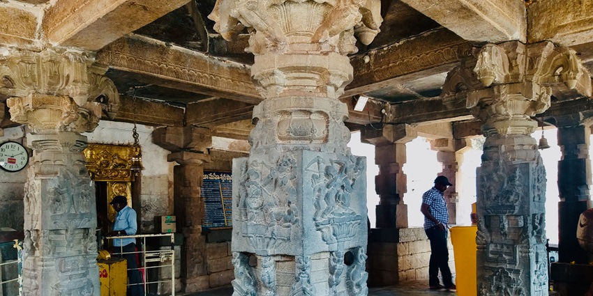 A picture of the inner sanctum of a historical temple with intricate carvings on its pillars