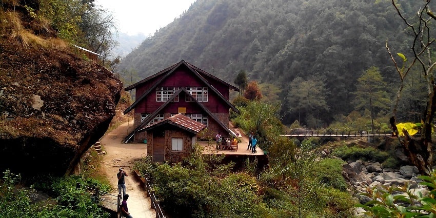 A wooden house nestled in Srikhola, one of the top places for camping in Darjeeling.