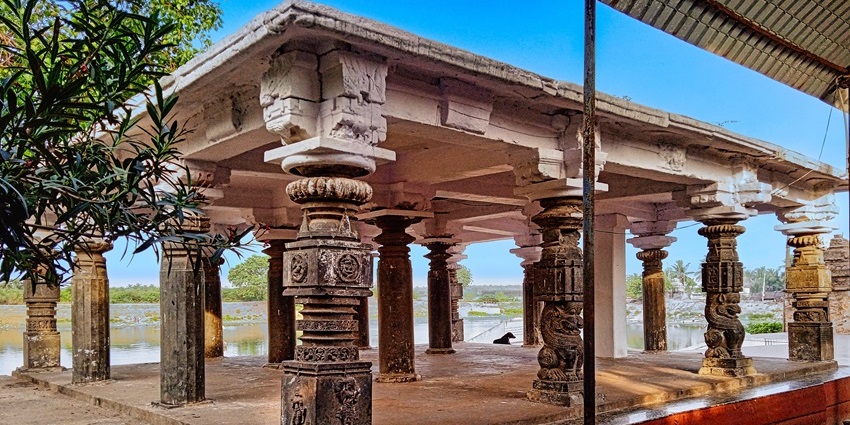 Image of an ancient temple courtyard by the lake and lush trees