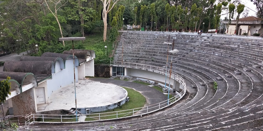 A Picture of an outdoor theatre stage with circular stands around the stage for viewers