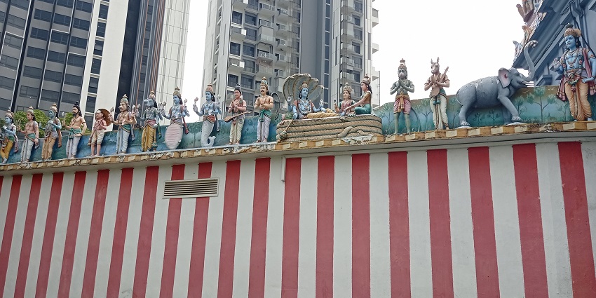 A picture of a Hindu temple in Singapore with idols of Hindu gods on a wall