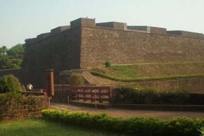 A picture of the St. Angelo Fort taken from a distance with the nearby gardens visible along with the walkway